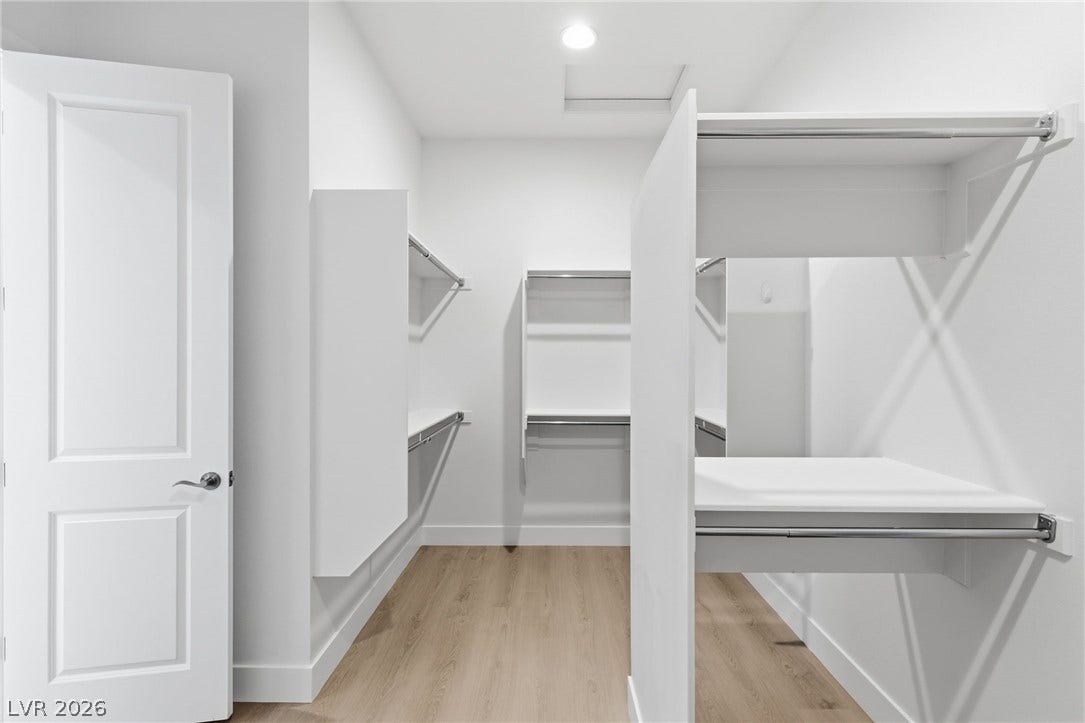 Ample storage solutions define this pristine walk-in closet, ready for personalized organization.