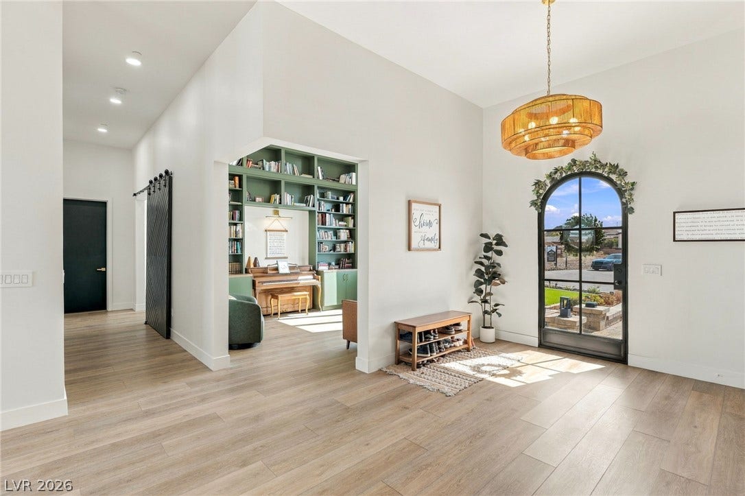 324 Wanda Road, Henderson, NV 89002 An arched entry door and wood-look flooring welcome guests into this light-filled foyer.