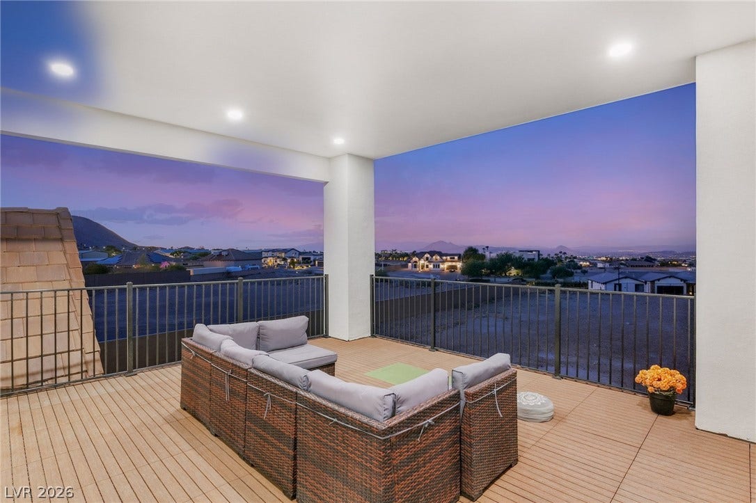 324 Wanda Road, Henderson, NV 89002 A spacious covered balcony provides panoramic mountain and valley views beneath a recessed-lit ceiling.