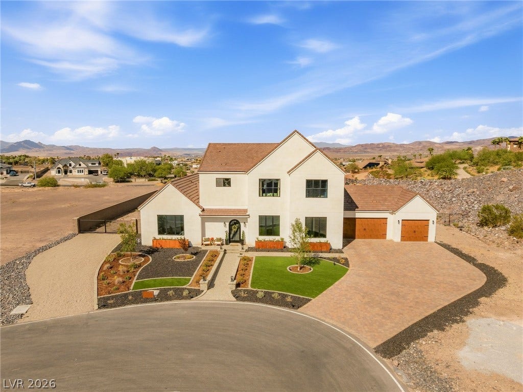 324 Wanda Road, Henderson, NV 89002 An elegant stucco facade harmonizes beautifully with paved driveways and clean desert landscaping.