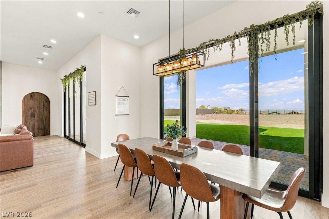 324 Wanda Road, Henderson, NV 89002 Massive sliding glass doors connect the airy dining space to an expansive outdoor lawn.