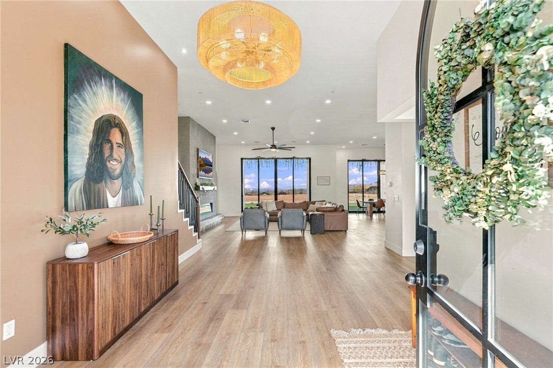 324 Wanda Road, Henderson, NV 89002 An inviting entryway transitions smoothly into a spacious open-concept living area with handsome wood floors.