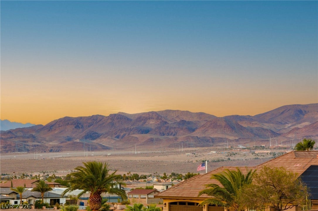 324 Wanda Road, Henderson, NV 89002 Dramatic desert peaks form a picturesque backdrop beyond the neighboring rooftops at sunset.