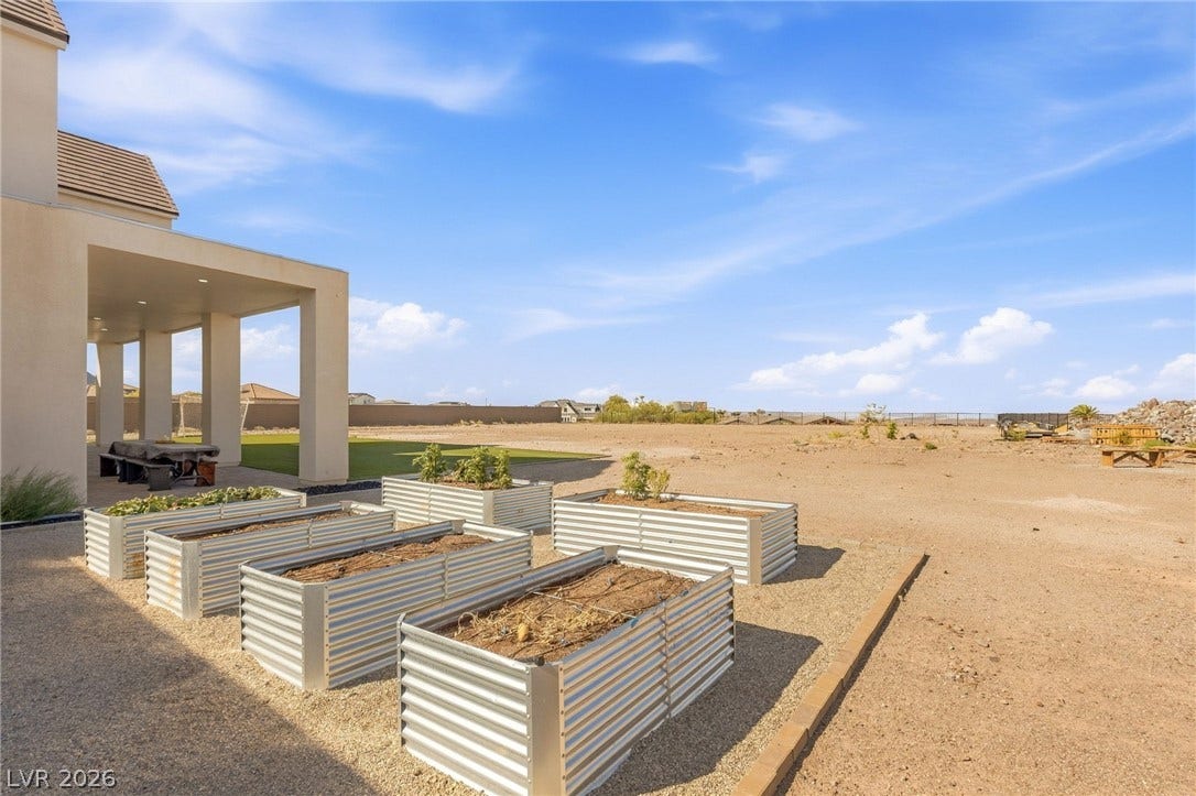 324 Wanda Road, Henderson, NV 89002 Corrugated metal raised garden beds sit alongside a spacious covered patio structure.