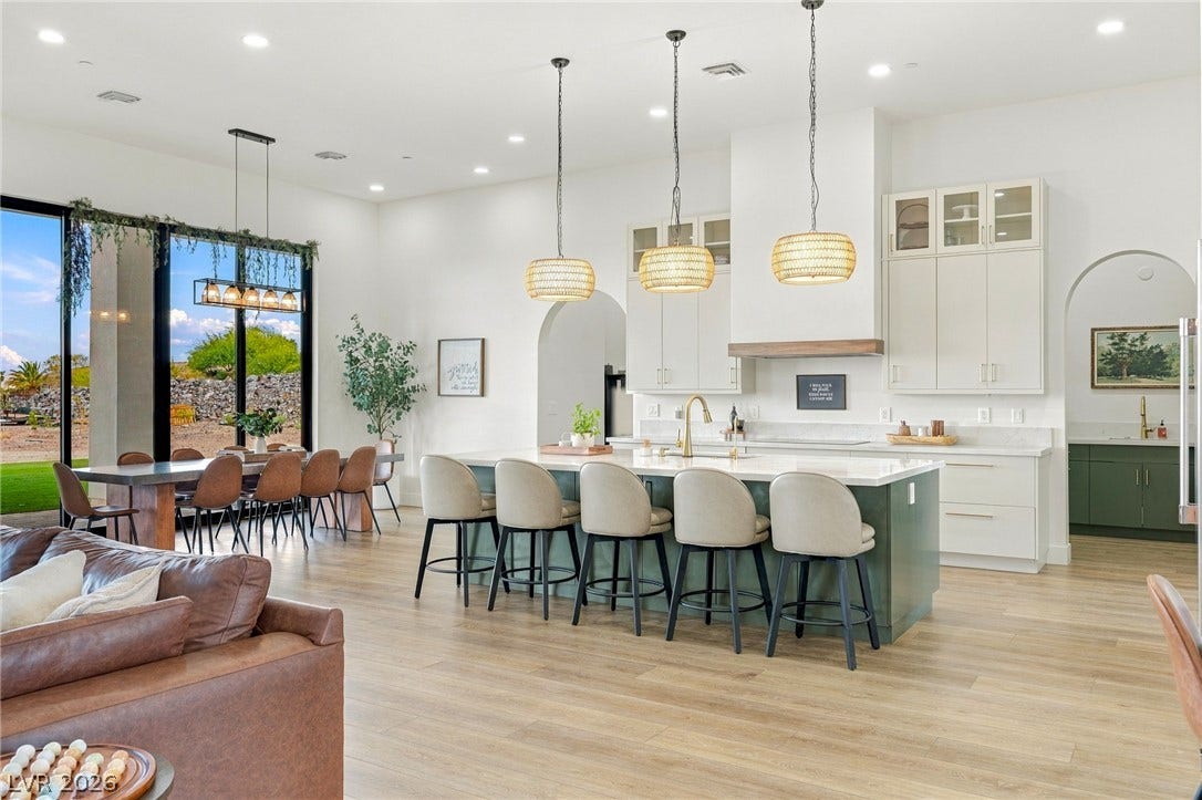 324 Wanda Road, Henderson, NV 89002 An open floorplan seamlessly connects the airy kitchen and dining area over light wood flooring.