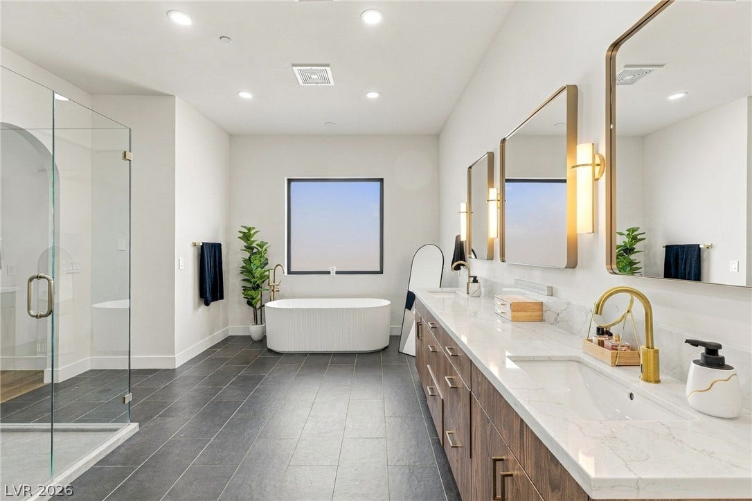 324 Wanda Road, Henderson, NV 89002 A freestanding tub under a window anchors this expansive bathroom with a dual vanity.