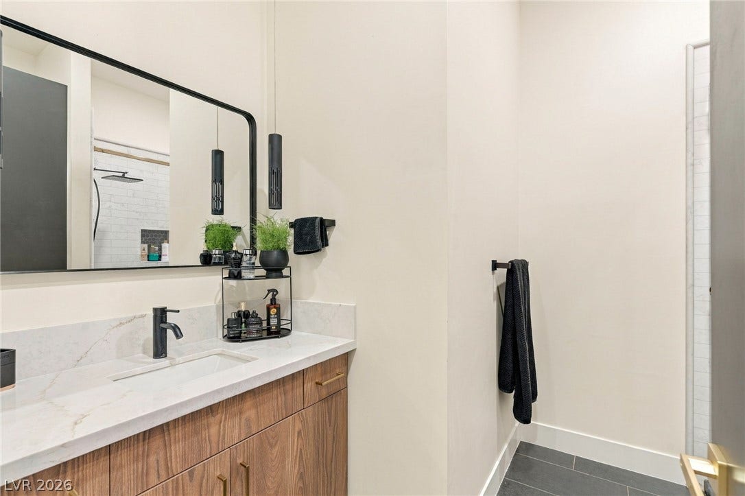 324 Wanda Road, Henderson, NV 89002 Clean lines and a stone-topped vanity define this contemporary restroom space.