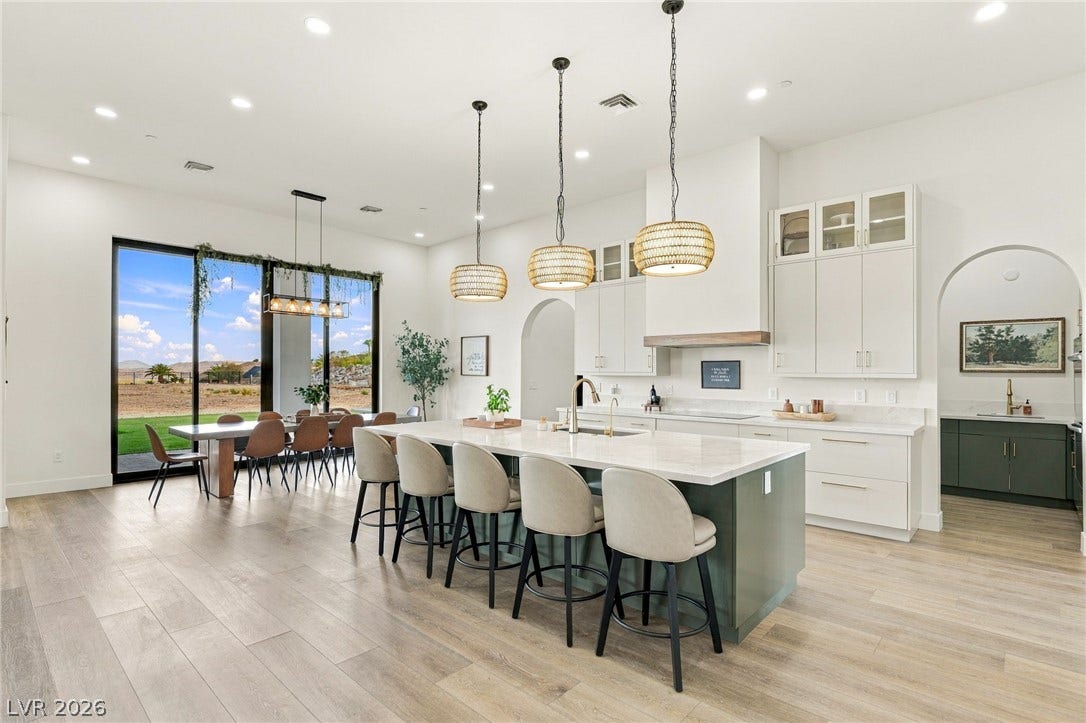 324 Wanda Road, Henderson, NV 89002 A spacious kitchen area opens to a dining space with expansive sliding glass doors.