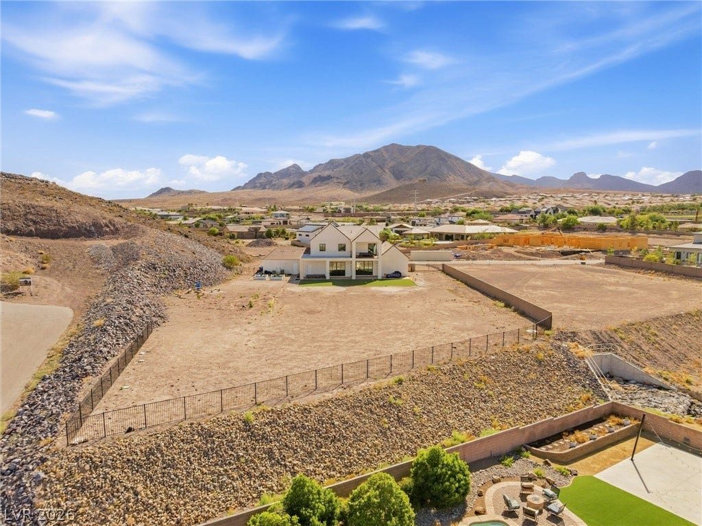 324 Wanda Road, Henderson, NV 89002 Dramatic mountain peaks frame this expansive property situated on an elevated desert lot.