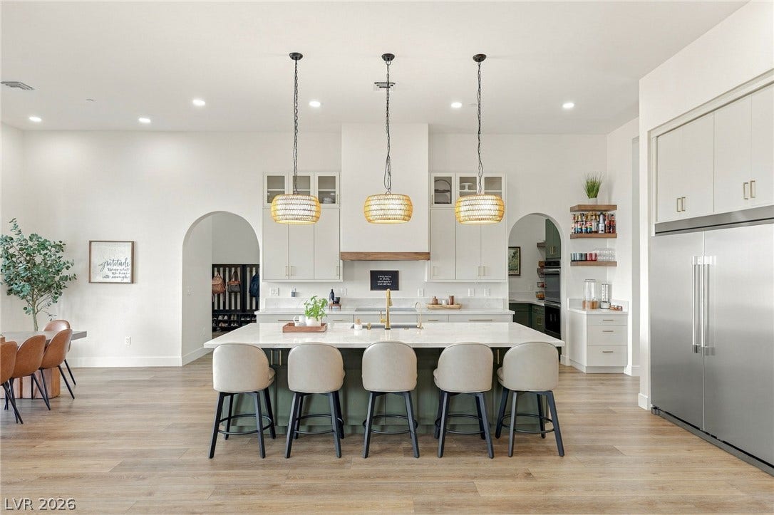 324 Wanda Road, Henderson, NV 89002 An open kitchen design showcases high ceilings, a grand island, and durable wood-look flooring.
