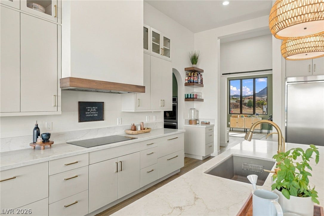 324 Wanda Road, Henderson, NV 89002 Clean lines and stone counters define this modern kitchen containing a large central island.