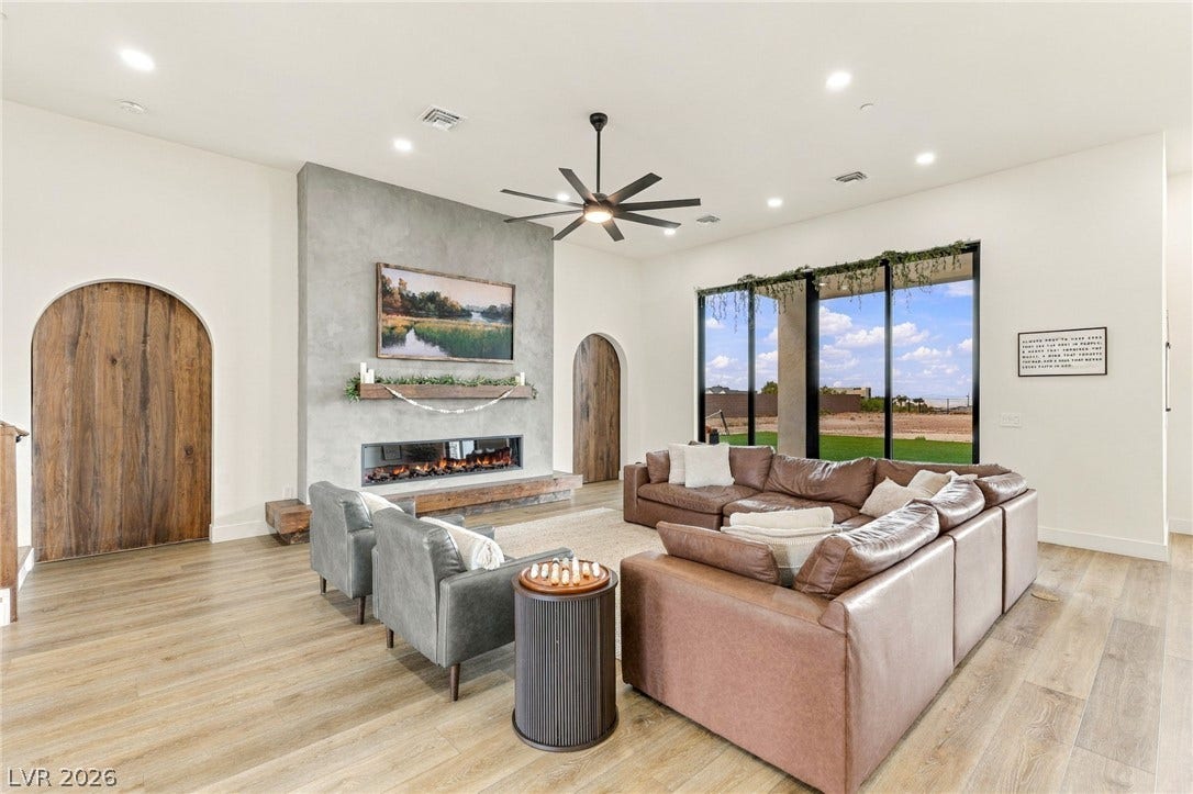 324 Wanda Road, Henderson, NV 89002 Arched wooden doorways and a modern linear fireplace elevate this light-filled living space.
