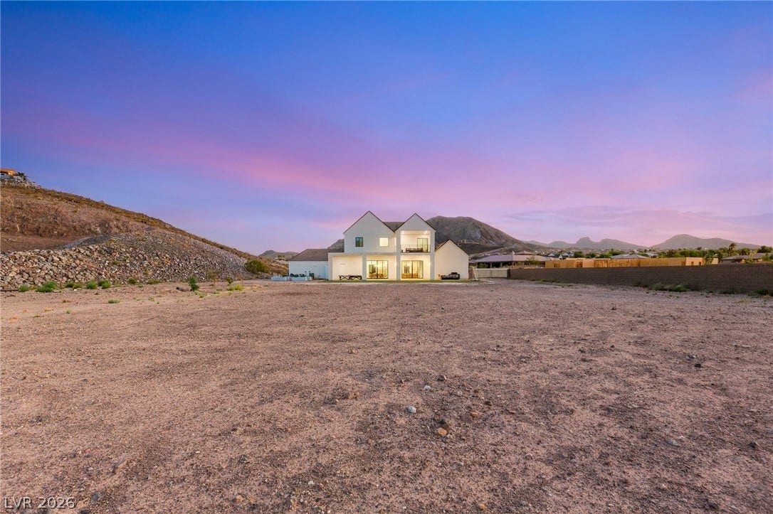 324 Wanda Road, Henderson, NV 89002 Dramatic mountain peaks frame this modern dual-gabled desert estate nestled on a sprawling private lot.