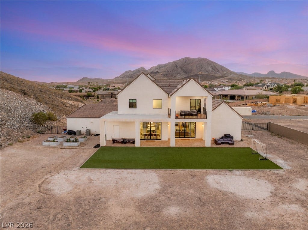 324 Wanda Road, Henderson, NV 89002 Dramatic mountain peaks frame this modern two-story home featuring a covered patio and upper balcony.