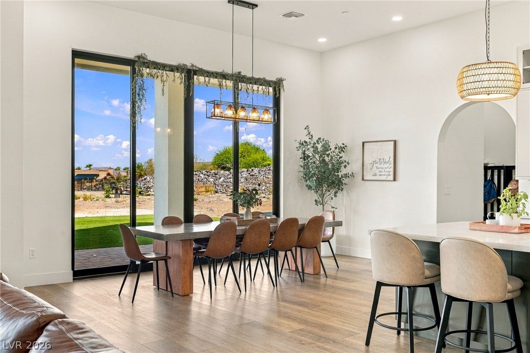 324 Wanda Road, Henderson, NV 89002 Towering glass doors frame tranquil desert views in this airy dining space.