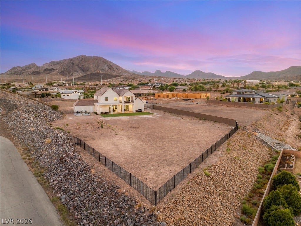 324 Wanda Road, Henderson, NV 89002 Dramatic mountain backdrops frame a spacious residential property featuring a large fenced lot.