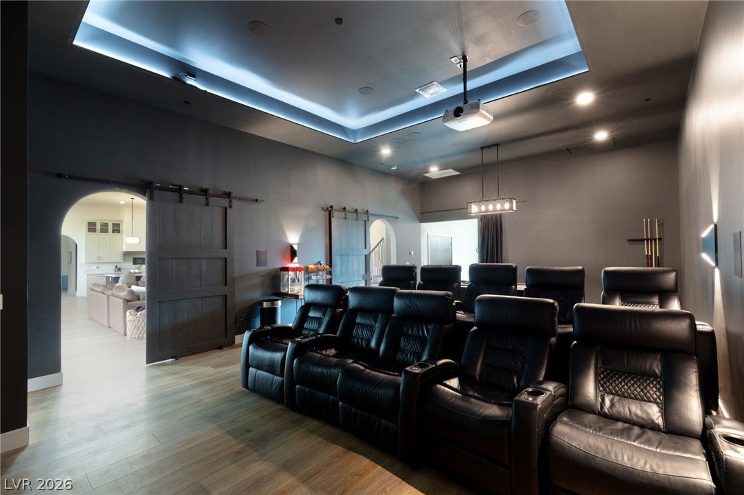 324 Wanda Road, Henderson, NV 89002 An illuminated tray ceiling and wood floors define this home theater space.