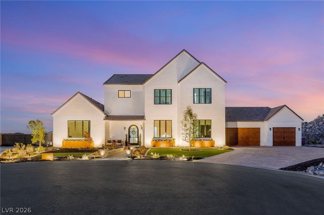 324 Wanda Road, Henderson, NV 89002 Crisp white stucco and dark-trimmed windows create striking architectural contrast under a twilight sky.