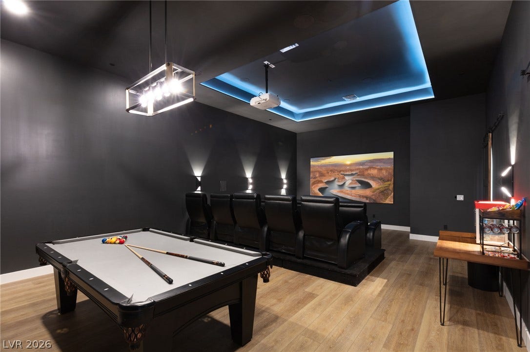 324 Wanda Road, Henderson, NV 89002 A tray ceiling highlights this versatile recreation room finished with wood flooring.