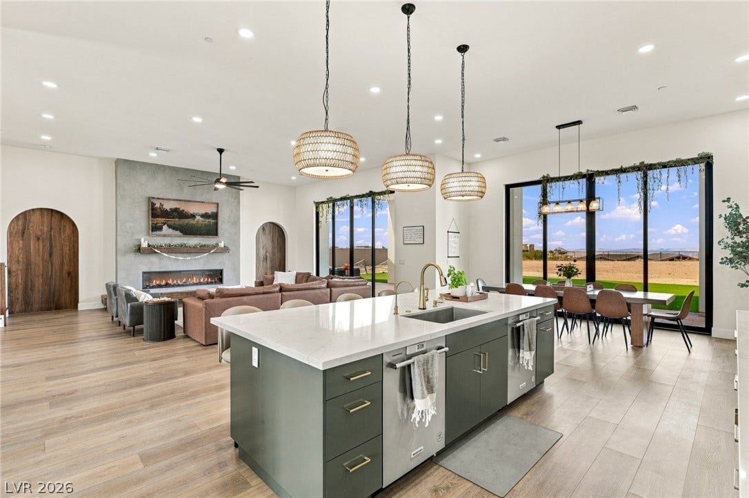324 Wanda Road, Henderson, NV 89002 An open-concept layout connects the kitchen to living and dining areas framed by massive windows.