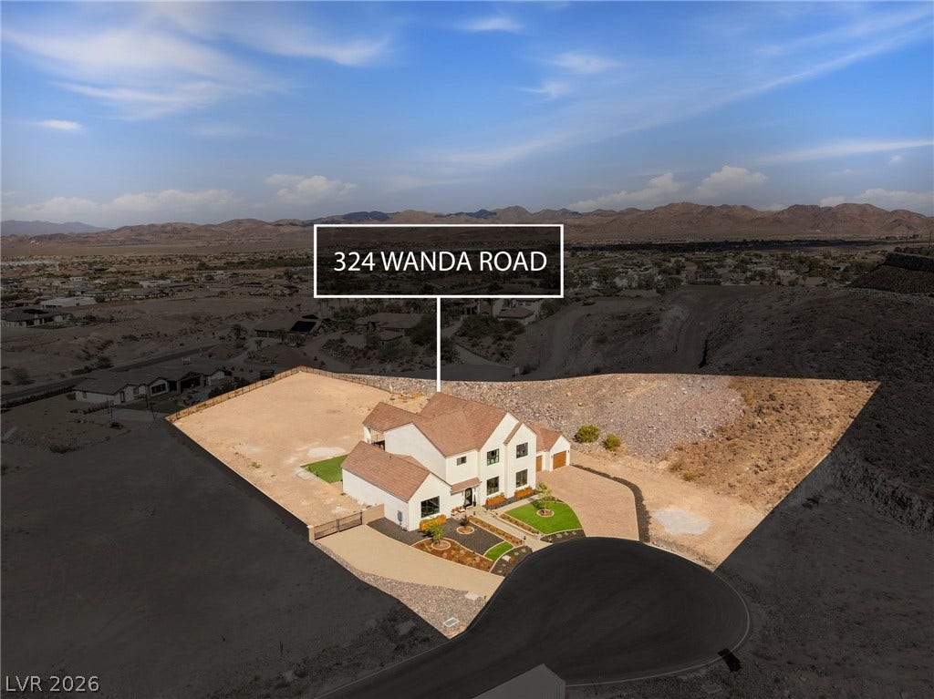 324 Wanda Road, Henderson, NV 89002 An aerial perspective showcases the home set against a dramatic desert and mountain backdrop.
