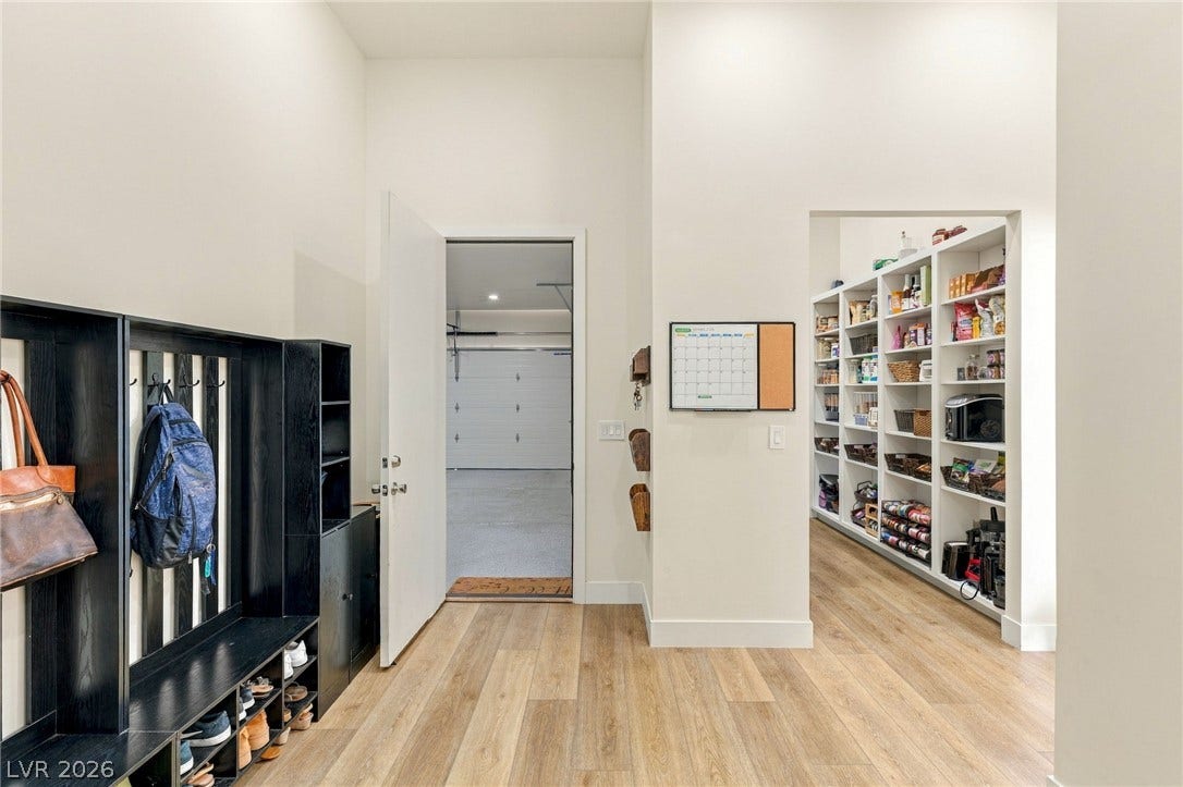 324 Wanda Road, Henderson, NV 89002 High ceilings and clean plank flooring frame a functional transition zone near the garage entry.