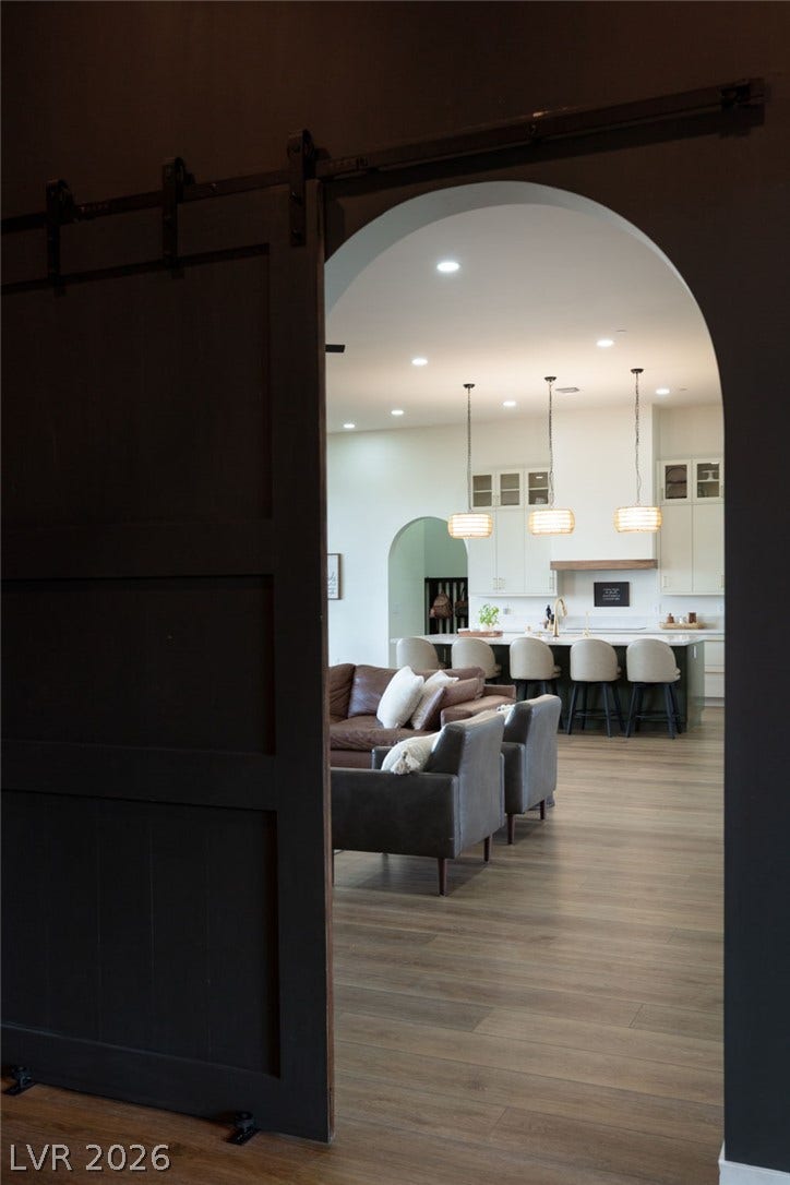 324 Wanda Road, Henderson, NV 89002 An arched doorway opens to reveal wood flooring and recessed lighting throughout the main level.