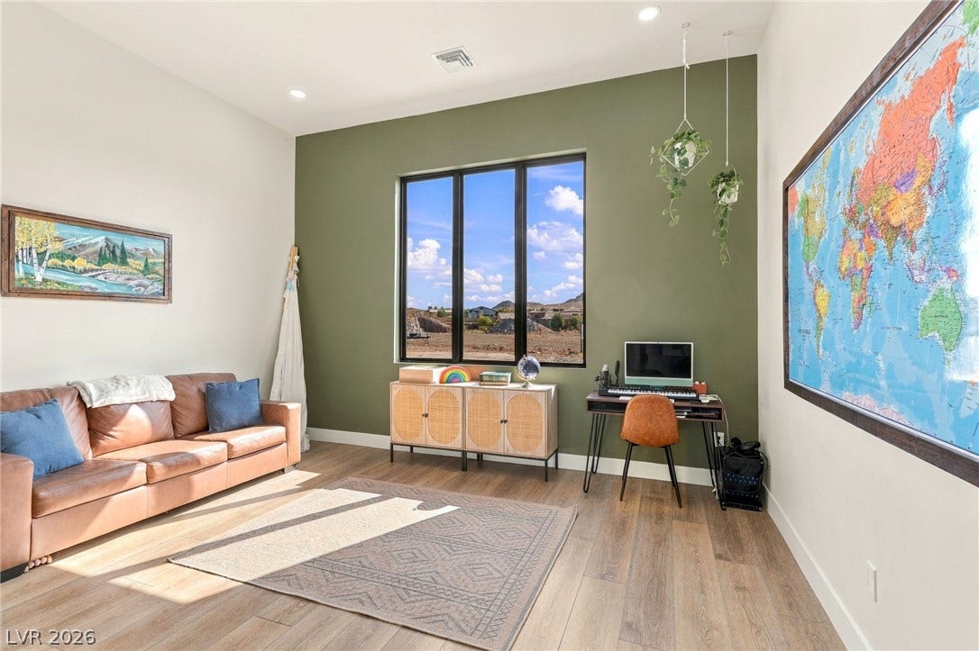 324 Wanda Road, Henderson, NV 89002 High ceilings and rich wood flooring frame this bright room featuring expansive picture windows.