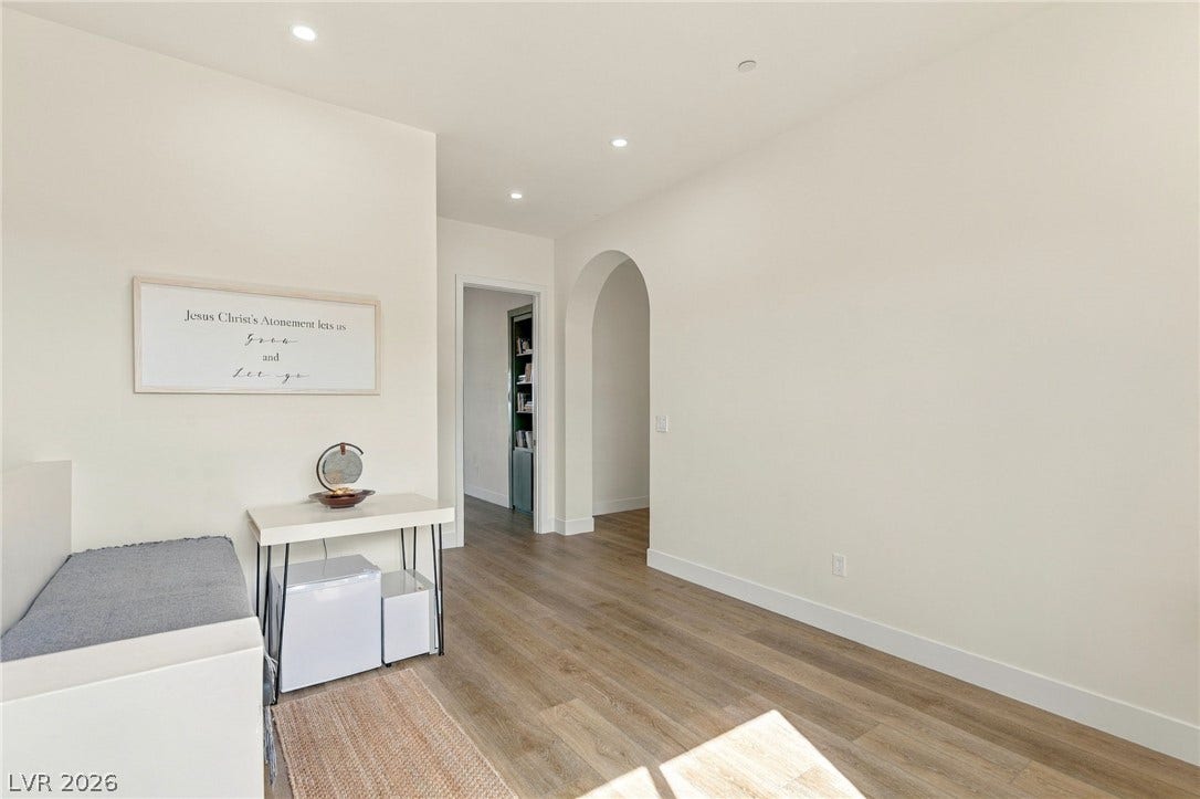 324 Wanda Road, Henderson, NV 89002 Smooth wood flooring and a graceful arched doorway define this inviting hallway entrance.