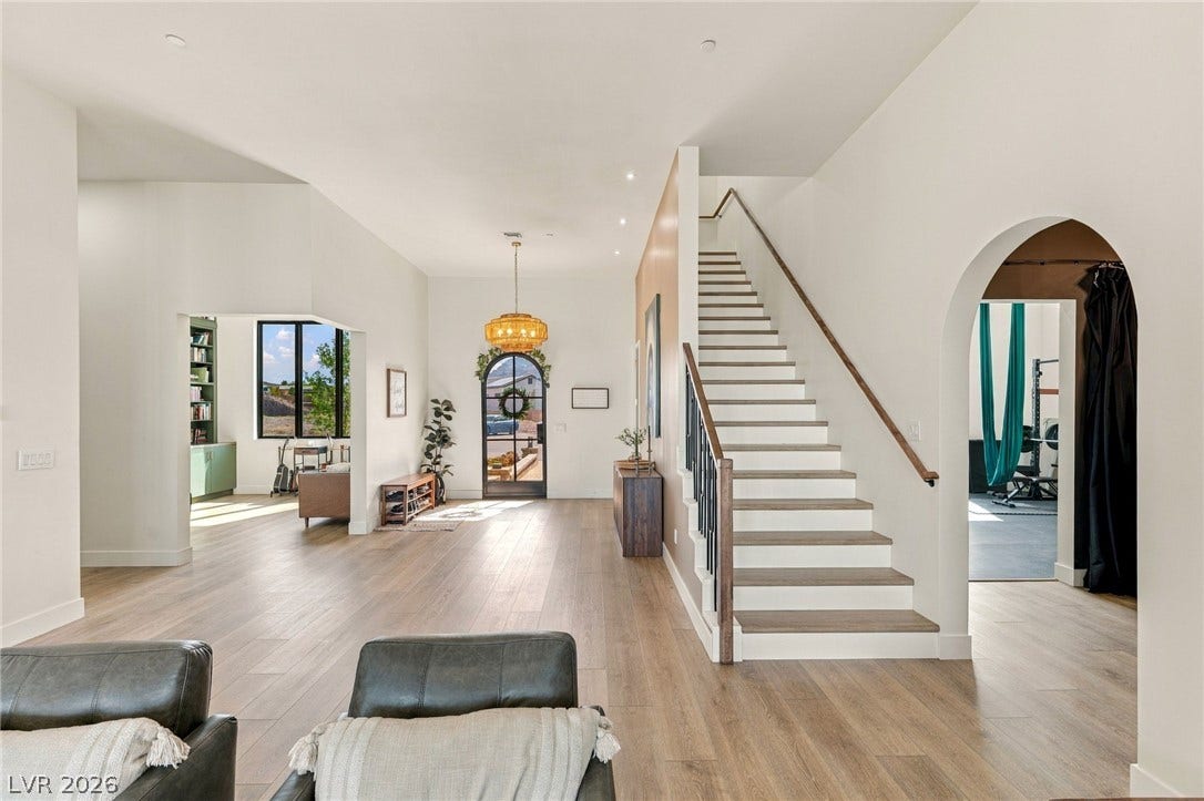324 Wanda Road, Henderson, NV 89002 Smooth wood floors flow past a crisp white staircase and an elegant arched doorway.