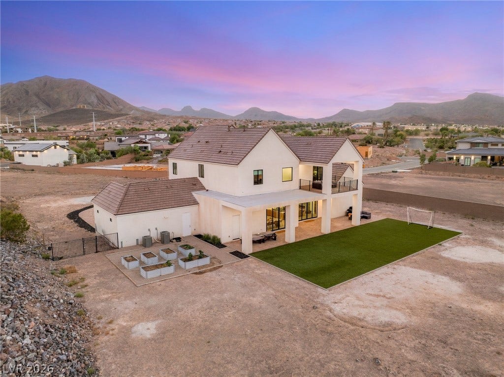 324 Wanda Road, Henderson, NV 89002 Dramatic mountain backdrops frame this modern desert estate with a covered patio and expansive yard.