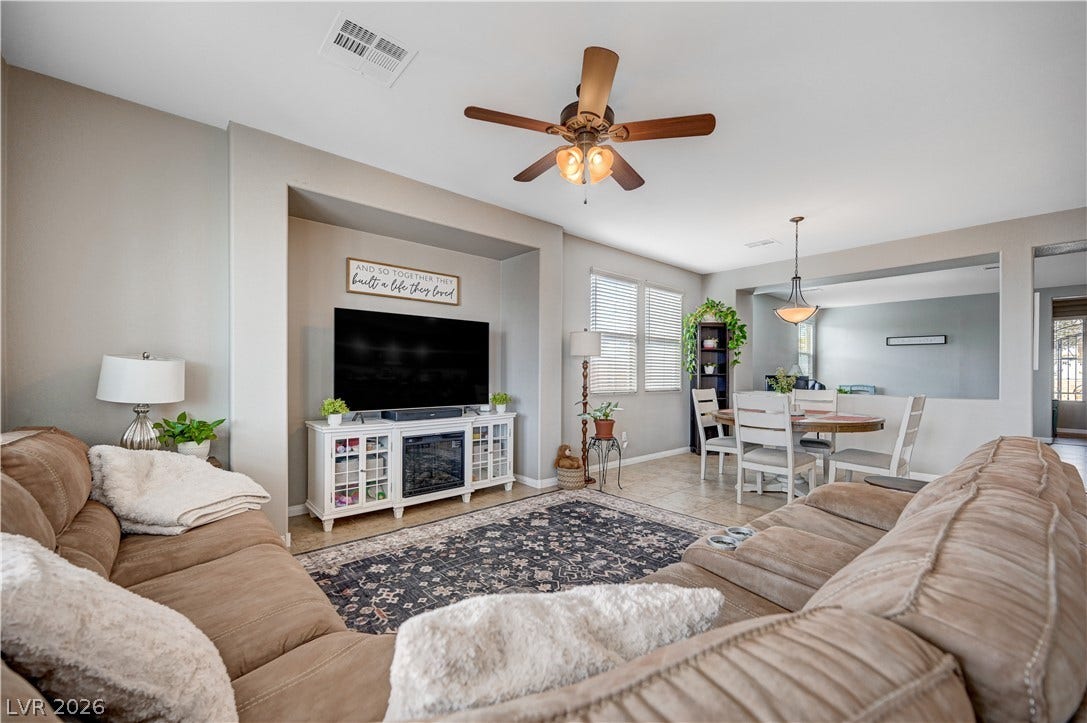 An open floor plan connects the comfortable living area directly to the dining room.