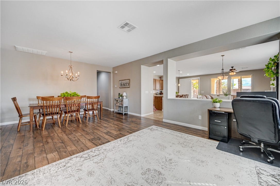 Gleaming hardwood floors and a spacious open-concept layout define this versatile living and dining area.