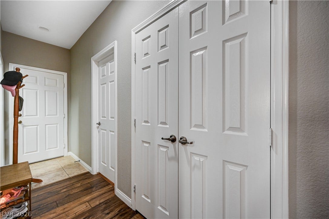 Hardwood floors and classic paneled doors define this functional entry hall space.