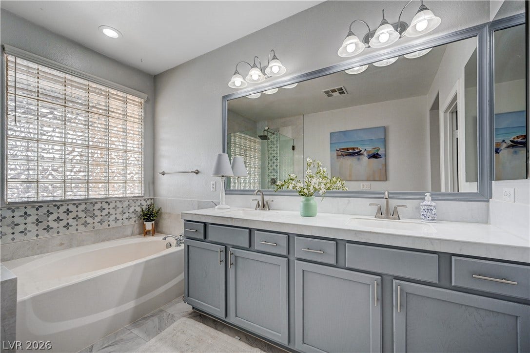 Double vanities and a soaking tub define this elegant bathroom space.