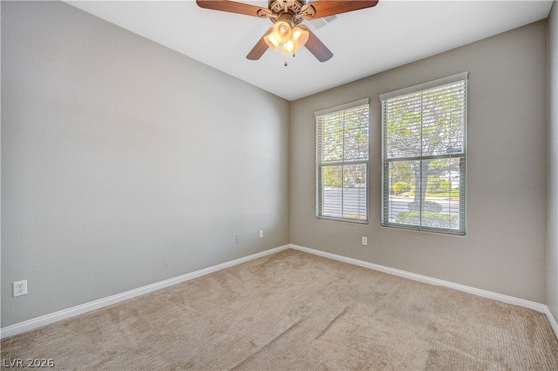 Plush carpeting and dual windows illuminate this versatile secondary bedroom.