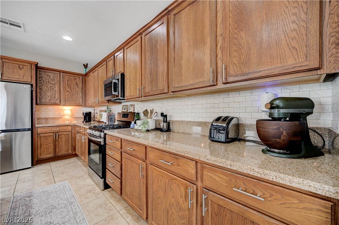 Rich wood cabinetry paired with granite countertops defines this classic kitchen layout.