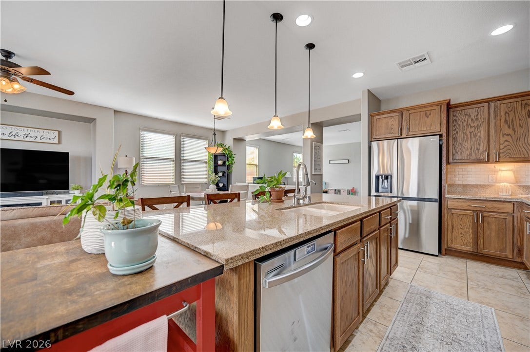 An open floor plan connects the kitchen to the bright dining and living spaces.
