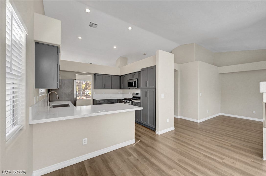 Clean lines and rich wood flooring define this open concept layout.