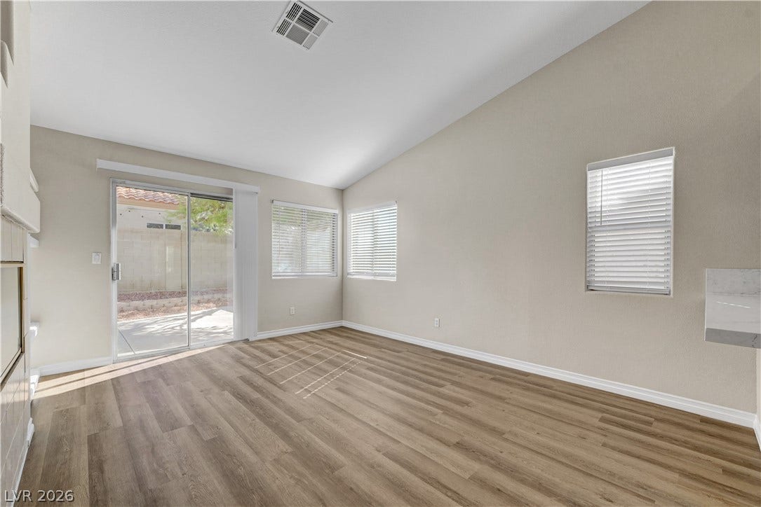 Sliding glass doors and high vaulted ceilings enhance this open living area.