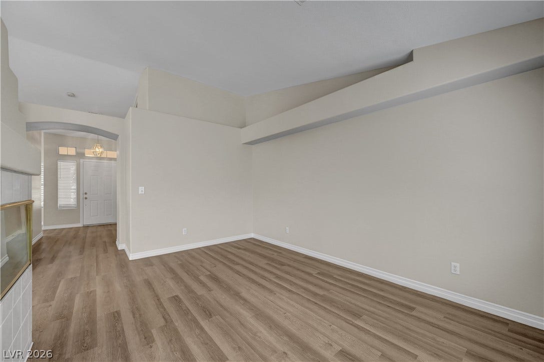 Vaulted ceilings and handsome wood-inspired flooring define this versatile main-level living space.