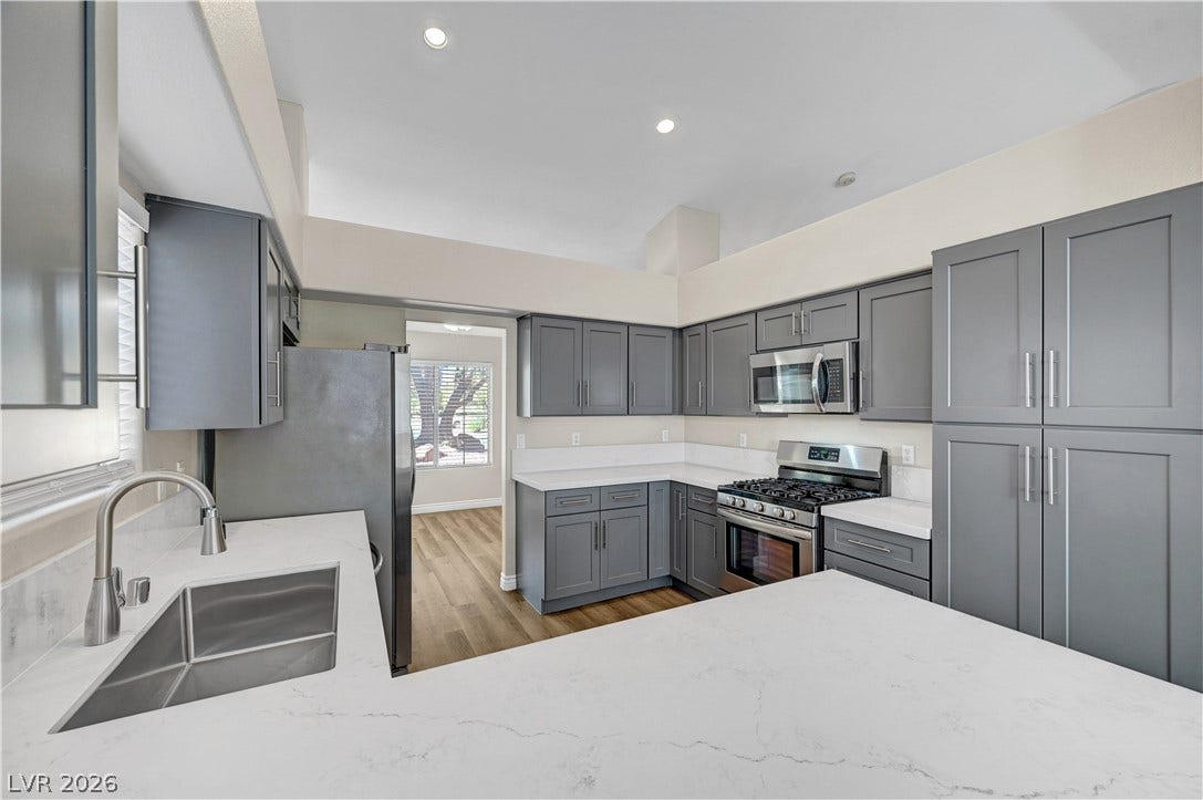 Crisp stone countertops pair with contemporary cabinetry in this modern kitchen space.