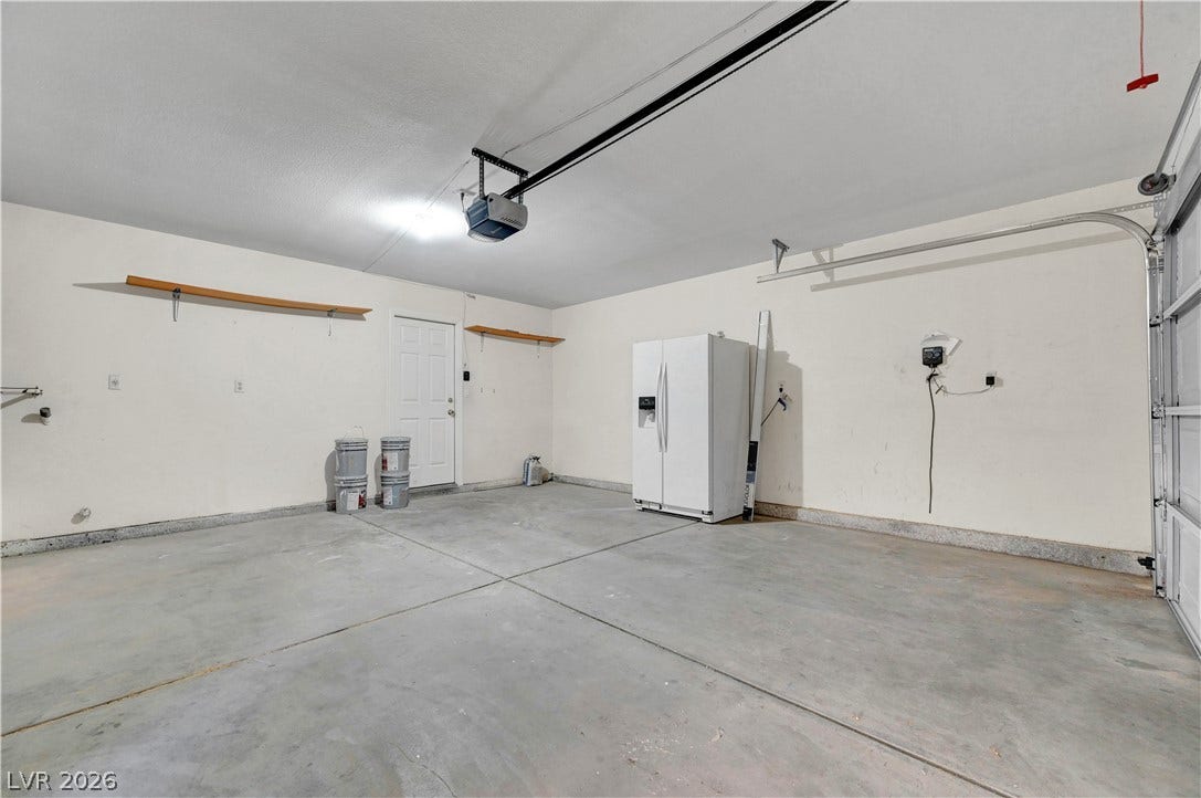 An expansive concrete floor and clean walls define this functional utility space.