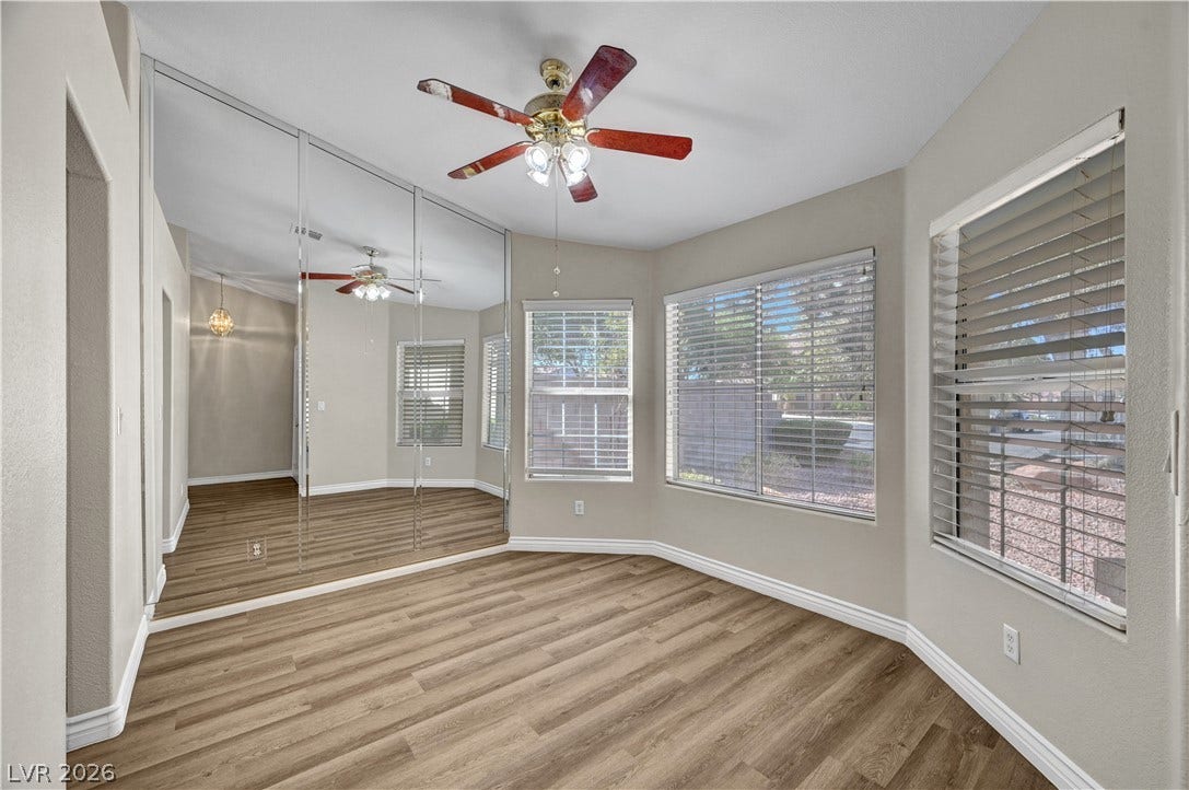 Warm wood flooring and mirrored walls enhance the light-filled atmosphere of this versatile room.