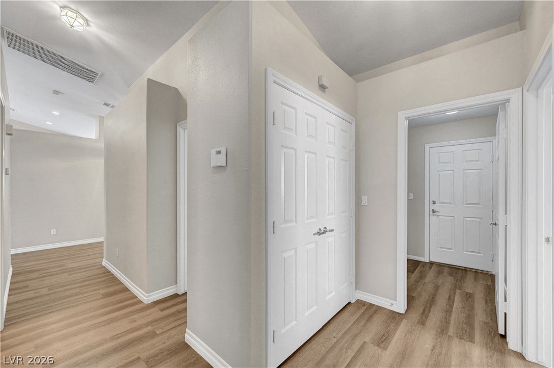Warm wood flooring and clean white moldings define this welcoming transition space.