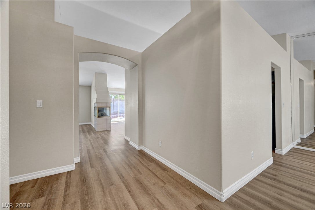 Clean architectural lines, high ceilings, and handsome wood-look flooring guide guests inside.