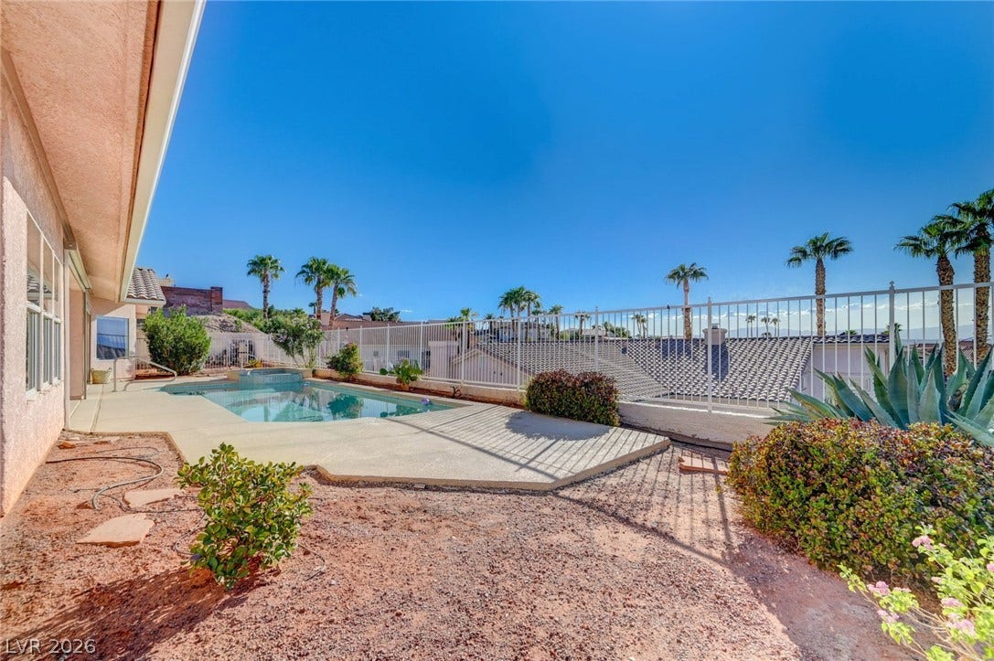 1112 Boletus Drive, Henderson, NV 89011 An inviting swimming pool area sits bordered by low-maintenance desert landscaping and security fencing.
