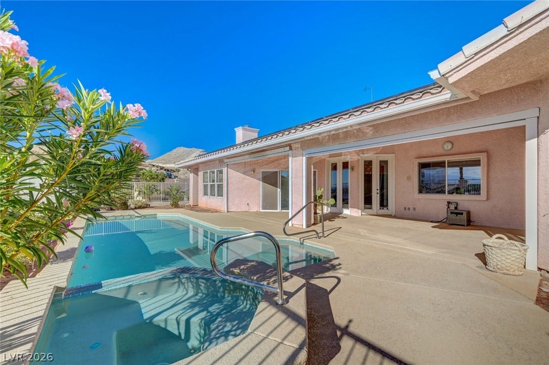 1112 Boletus Drive, Henderson, NV 89011 A sparkling swimming pool and integrated spa sit alongside a spacious covered concrete patio.