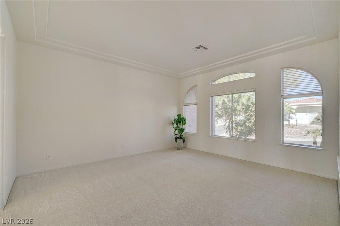 1112 Boletus Drive, Henderson, NV 89011 Arched windows invite natural light across the plush carpeting and high recessed ceiling.