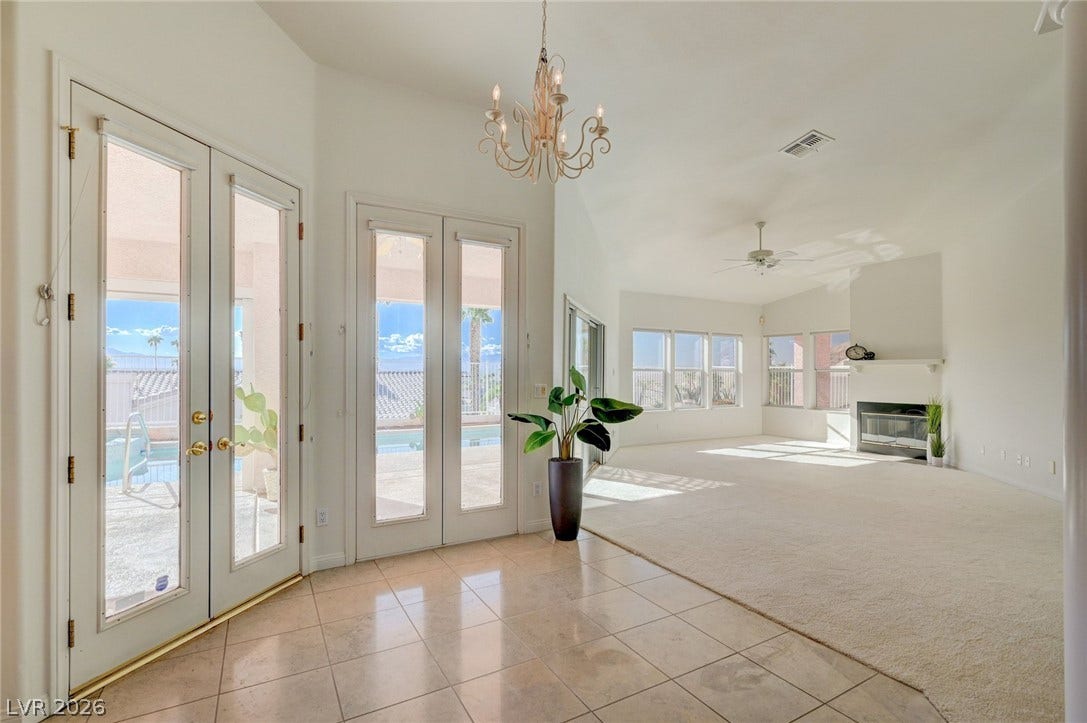 1112 Boletus Drive, Henderson, NV 89011 Double glass doors lead into an airy interior highlighted by high ceilings and tile flooring.